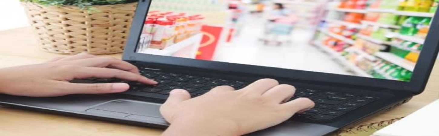 Person on their laptop with a screen of someone shopping at a grocery store